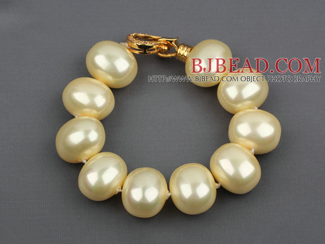 high quality egg shape light yellow sea shell beads bracelet with gold plated clasp